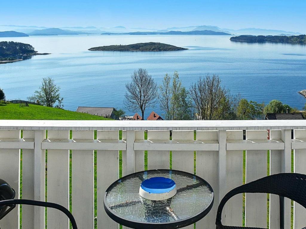 a table on a balcony with a view of the water at Apartment Onarheim II in Onarheim