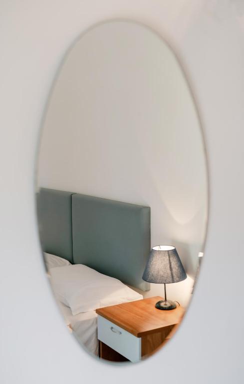 a bedroom with a bed and a table with a lamp at Solcalante in Procida
