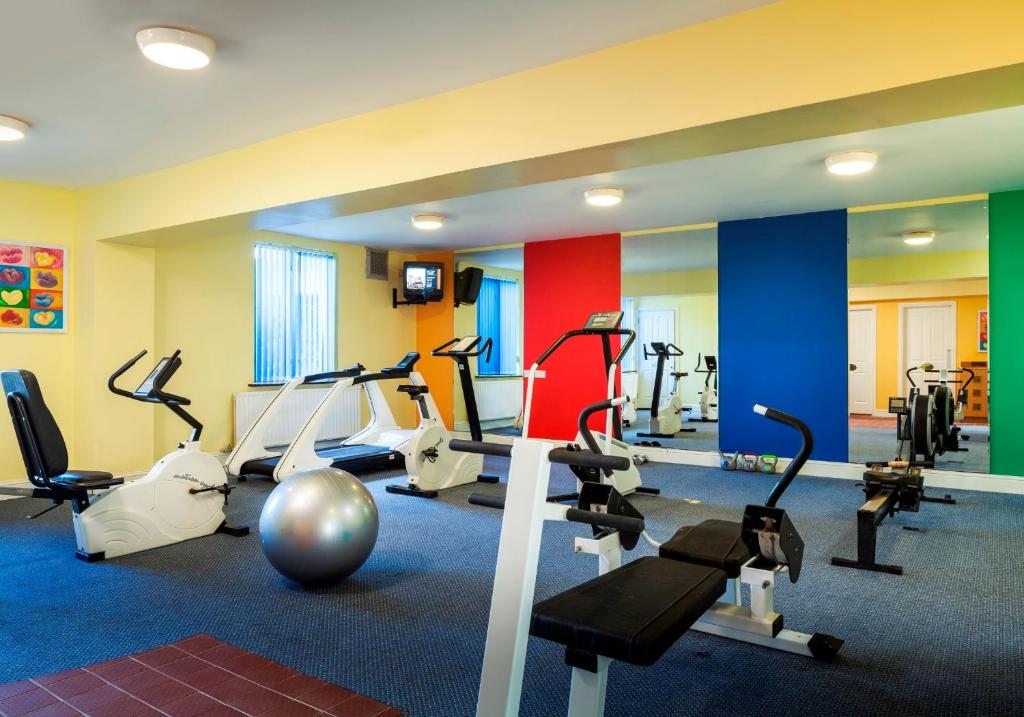 a gym with several treadmills and exercise machines at Park Inn by Radisson Shannon Airport in Shannon