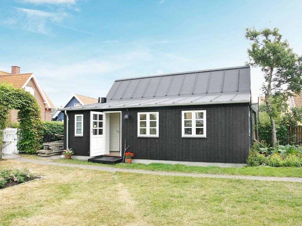 a black and white house with a yard at Holiday home in Skagen 4 in Skagen