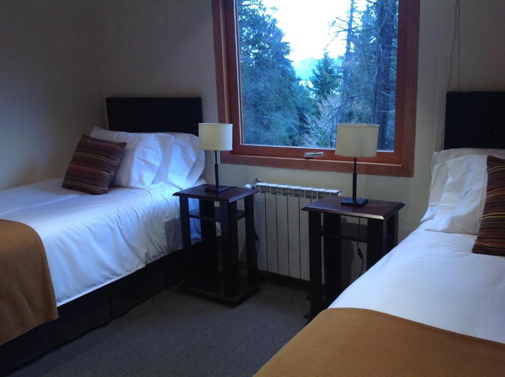 Un pat sau paturi într-o cameră la Maria del Bosque Apart Hotel / Cabañas
