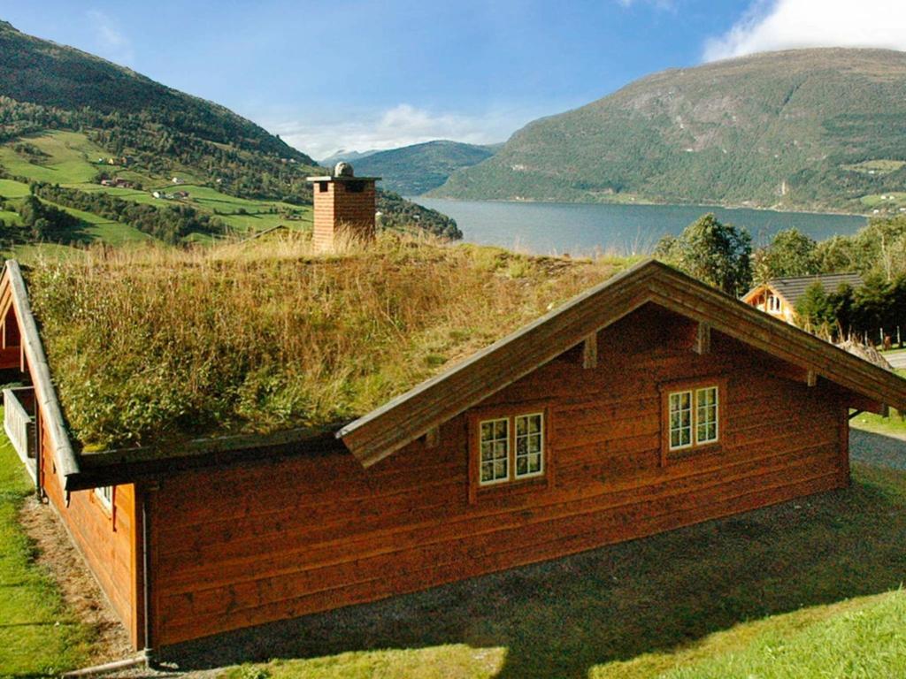 a house with a grass roof on top of it at Four-Bedroom Holiday home in Olden 2 in Olden