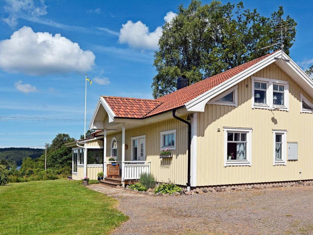 a yellow house with a red roof at One-Bedroom Holiday home in Ullared in Ullared