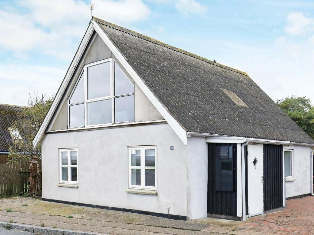 a white house with a black roof at Three-Bedroom Holiday home in Vestervig 14 in Vestervig