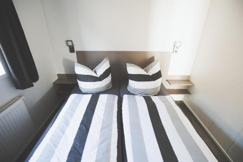 Postel nebo postele na pokoji v ubytování Lodgepark Goitzsche GmbH