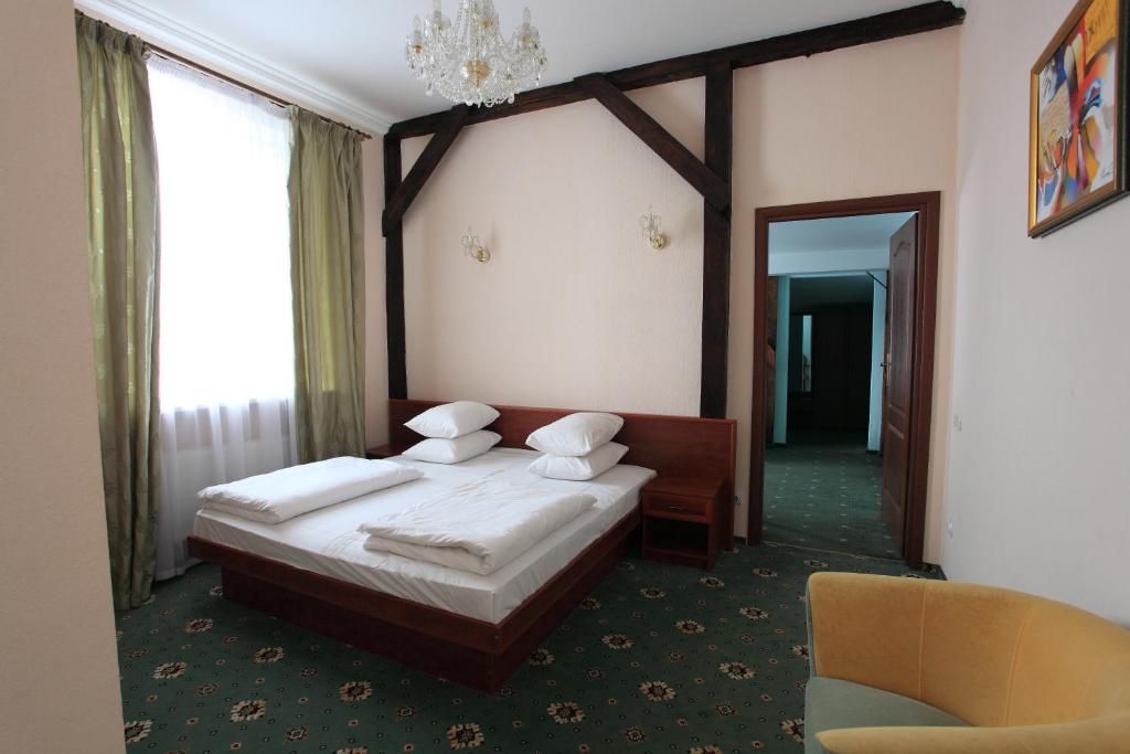 a bedroom with a large bed and a large mirror at Hotel Mars in Lviv