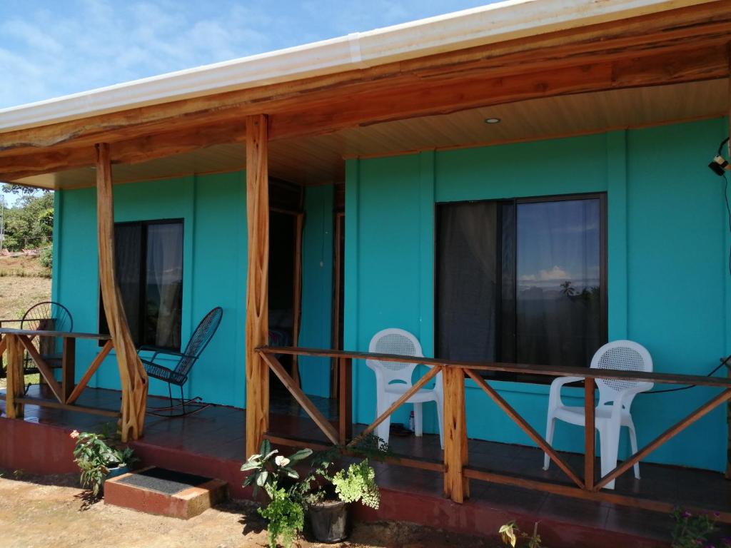 a green house with a wooden roof at Drake Bay Casita Sun SHINE in Drake