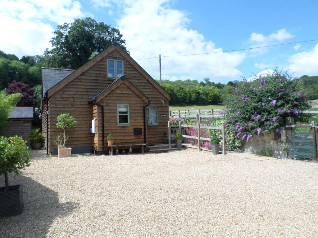 a small wooden cabin with a gravel yard at The Old Stables @ Linden Cottage in Goring