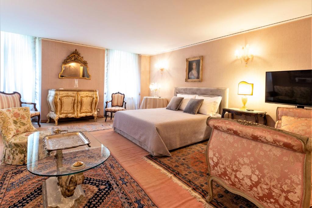 a bedroom with a bed and a living room at Apartment Rigoletto San Marco Square in Venice
