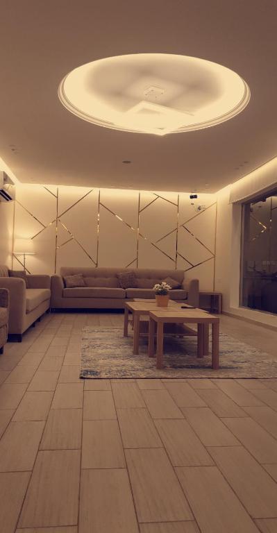 a living room with a couch and a table at Al Somow Chalets in Dahaban