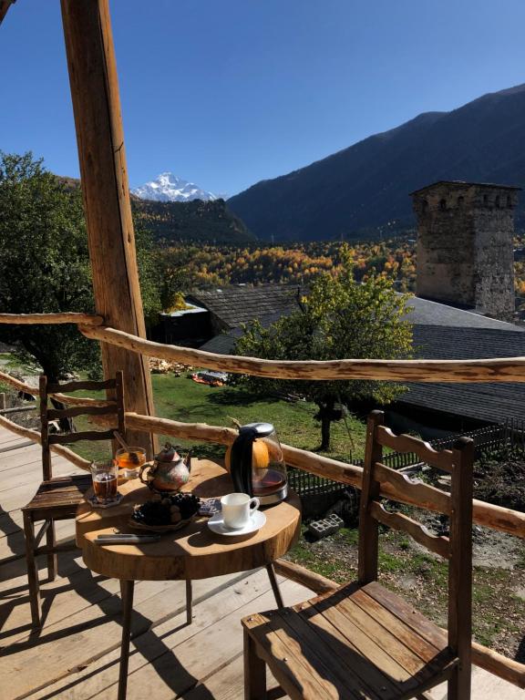 a table with a tea set on top of a balcony at Guest House Keti Margiani Mestia in Mestia