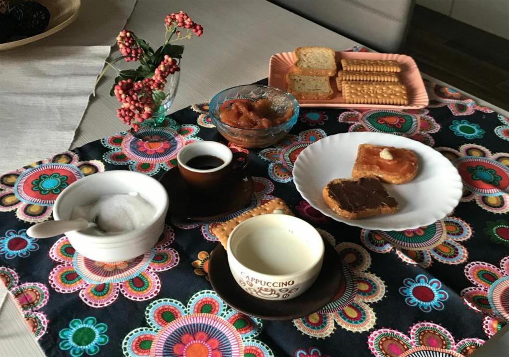 a table with two cups of coffee and a plate of bread at La Bellavista Mola di Bari in Mola di Bari