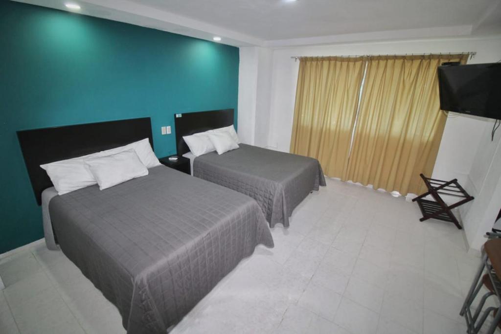 Postel nebo postele na pokoji v ubytování EMS Hoteles Boca del Río