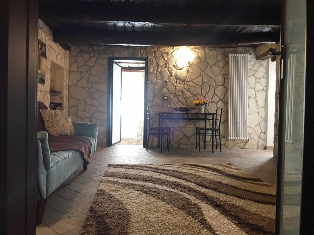 sala de estar con sofá y mesa en Casa Lisetta, en Villa D'agri