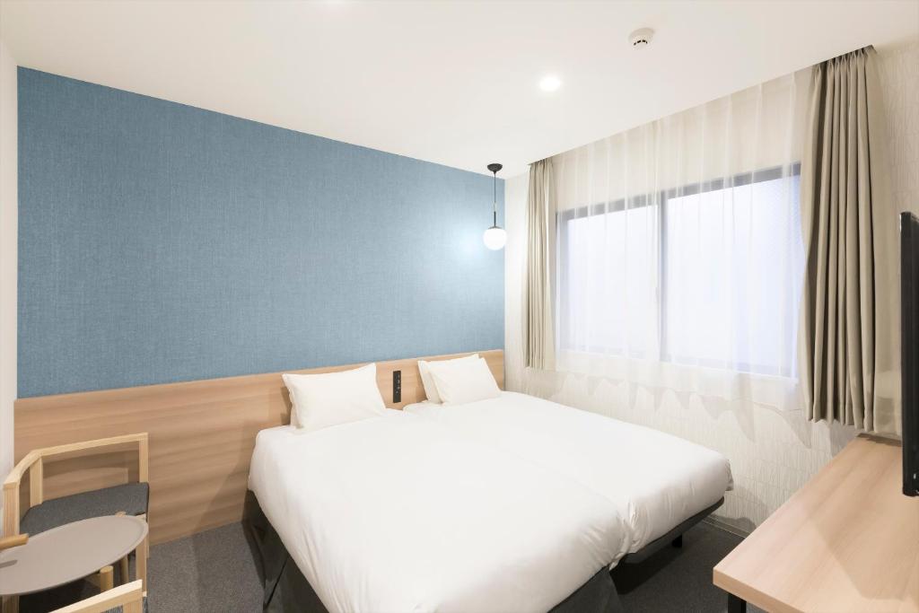 Postel nebo postele na pokoji v ubytování M's Hotel Sanjo Omiya