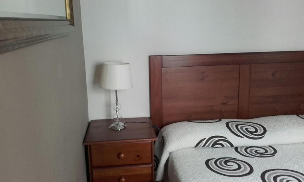 a bedroom with a bed and a lamp on a nightstand at Casa del Cu bano B- Biosphere Reserve in Santa Cruz de Tenerife
