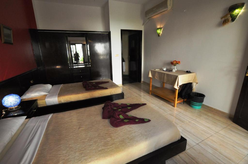 Postel nebo postele na pokoji v ubytování El Nakhil Hotel