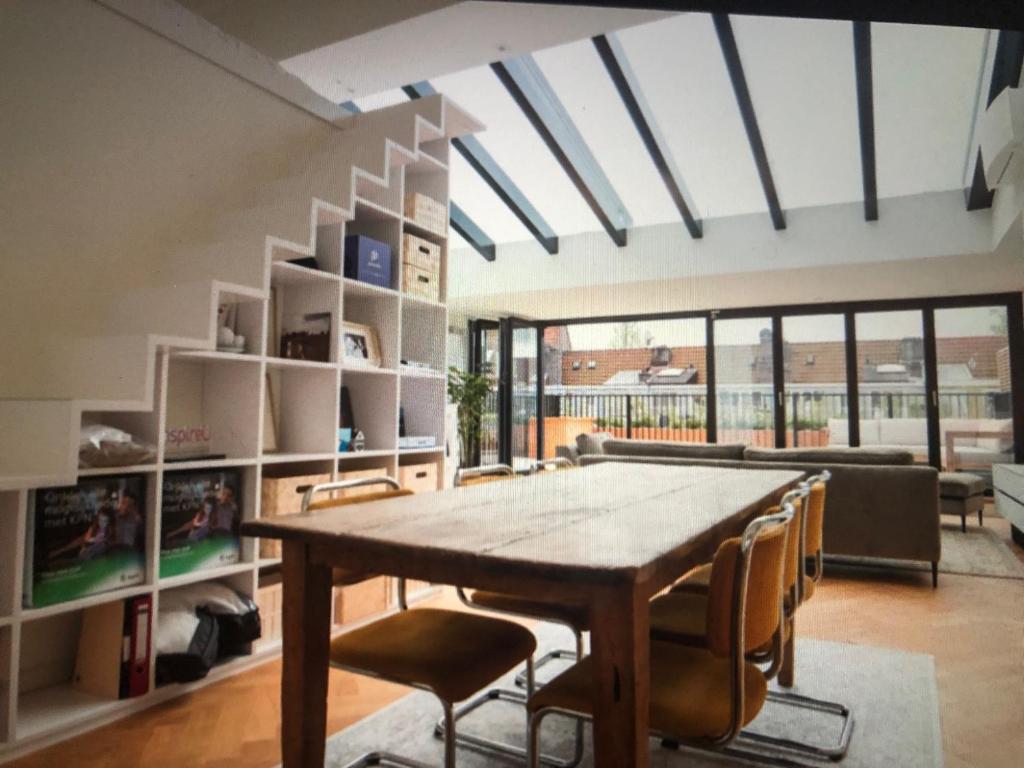 - une salle à manger avec une table et des chaises en bois dans l'établissement Fantastic Bright Penthouse, à Amsterdam