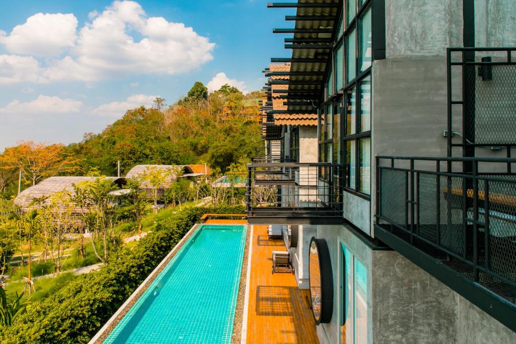 a swimming pool on the side of a building at Vino Neste Private Pool Villas in Ban Khanong Phra Tai