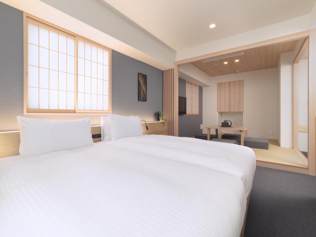 Postel nebo postele na pokoji v ubytování MIMARU Tokyo Akasaka