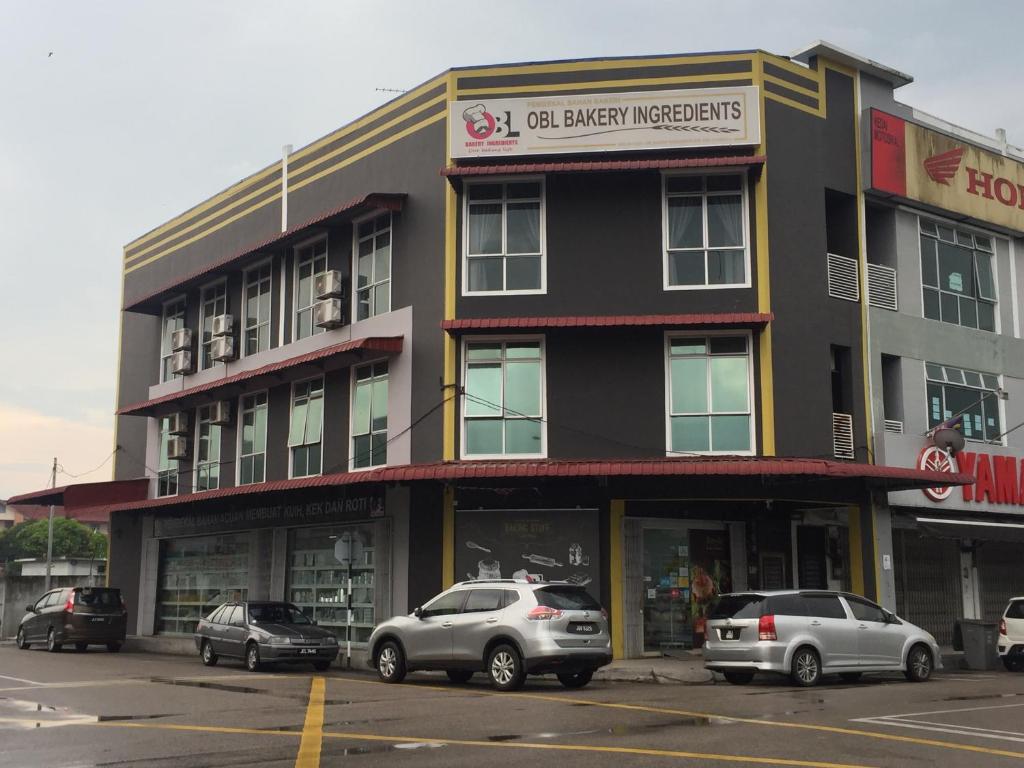 a building with cars parked in front of it at BENUTHOMESTAY in Johor Bahru