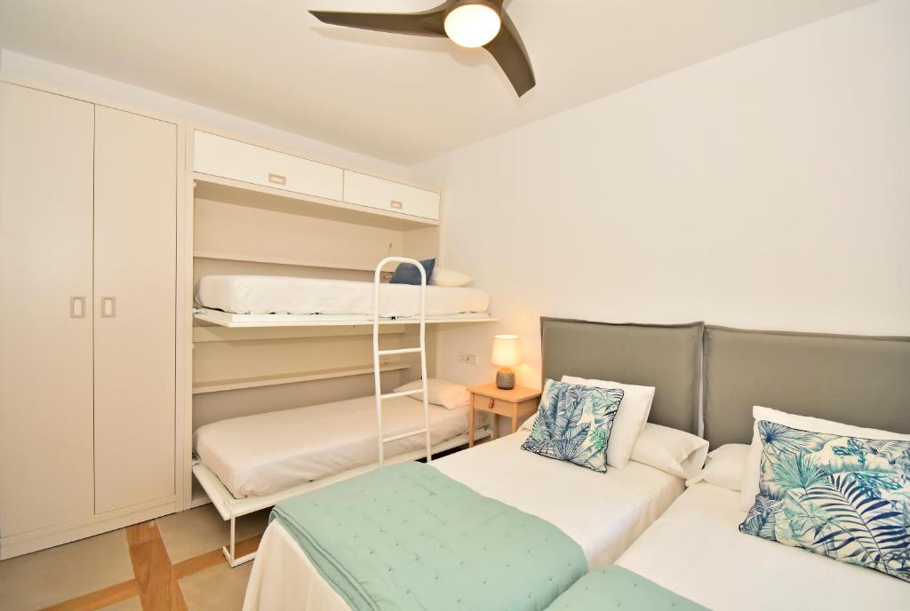 A bed or beds in a room at 70sqm private terrace in front of the sea & 107sqm brand new apartment