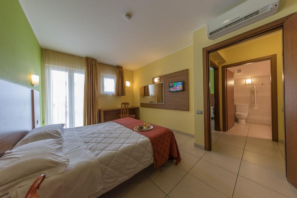 Postel nebo postele na pokoji v ubytování Hotel La Ninfea