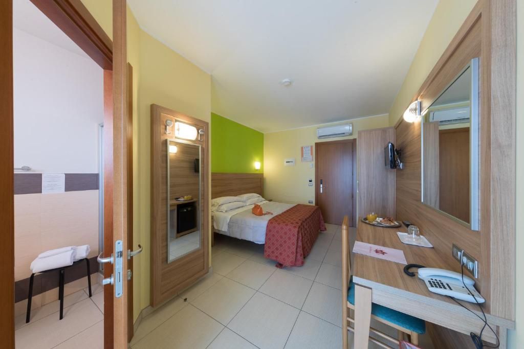 Postel nebo postele na pokoji v ubytování Hotel La Ninfea