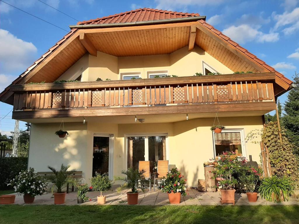 a house with a deck on top of it at FeWo Hohen Neuendorf bei Berlin mit Sauna und Fuß-SPA in Hohen Neuendorf