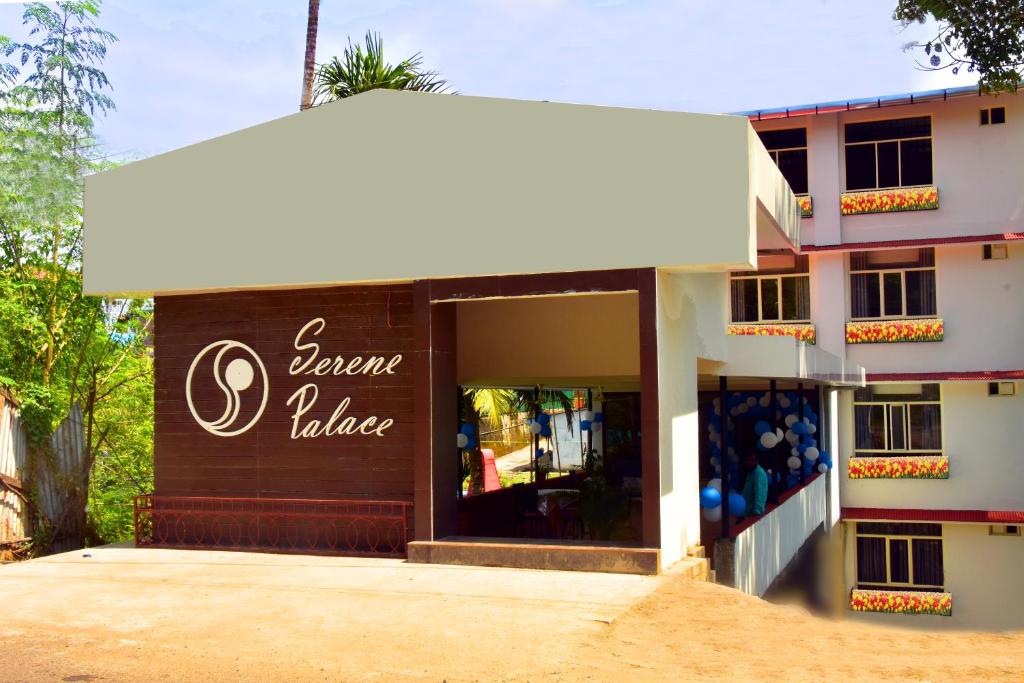 a store with a sign on the front of a building at Hotel Serene Palace in Port Blair