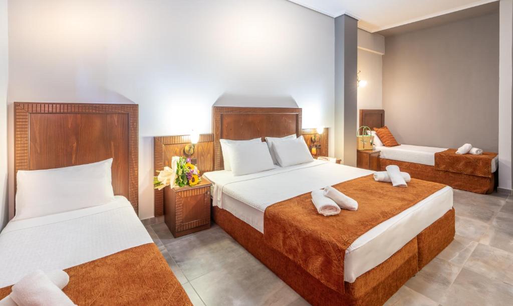 Postel nebo postele na pokoji v ubytování Paralia Beach Boutique Hotel