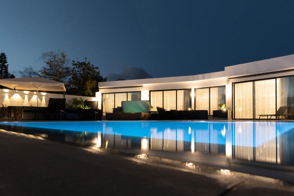 a house with a swimming pool at night at Estellar in Puerto del Carmen