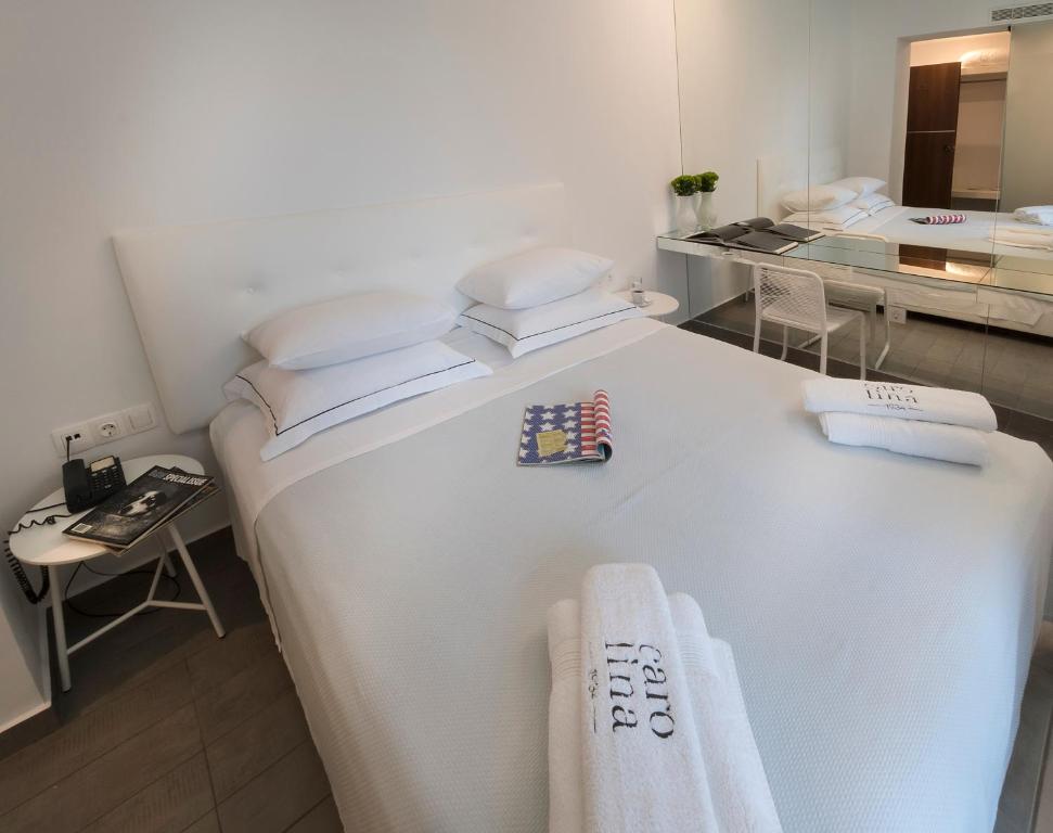 Postel nebo postele na pokoji v ubytování Carolina Hotel since 1934