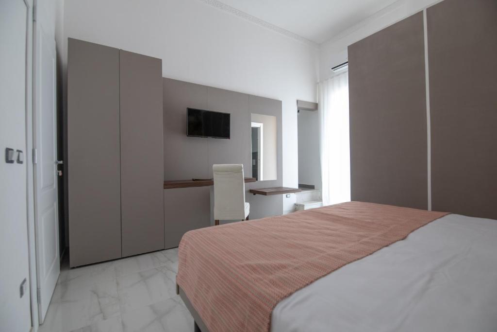 Posteľ alebo postele v izbe v ubytovaní Palazzo Caracciolo del Sole