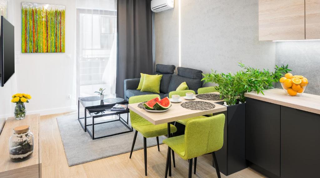 una cucina e un soggiorno con tavolo e frutta di Rakowicka 20h Apartments by LET'S KRAKOW a Cracovia