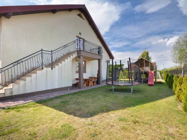 a house with a yard with a playground at Pokoje Gościnne R10 in Rewa