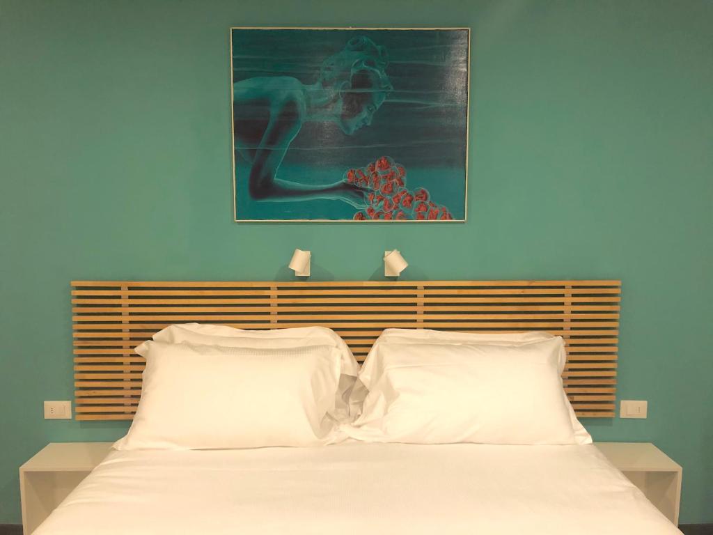 Posteľ alebo postele v izbe v ubytovaní Mimì Rooms&Studios