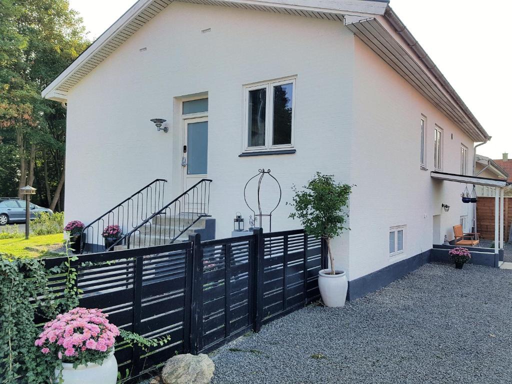 a white house with a black fence at Koege Guesthouse in Køge