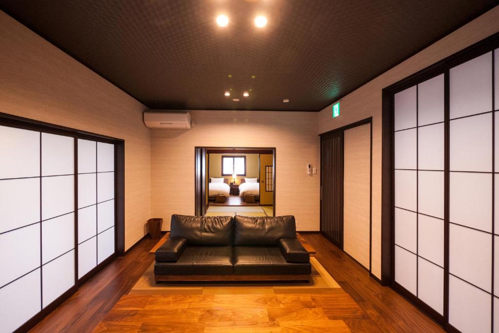 a living room with a couch and a bedroom at Kimachi-tei（きまち亭） in Toyama