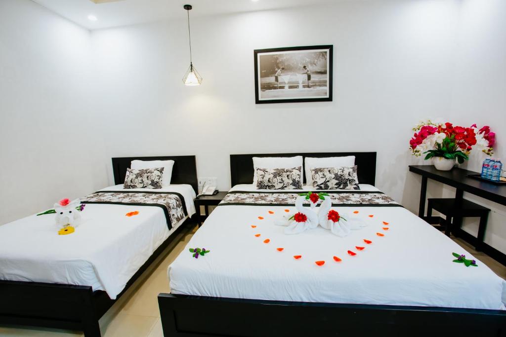 Postel nebo postele na pokoji v ubytování Hoianation Villas Hotel