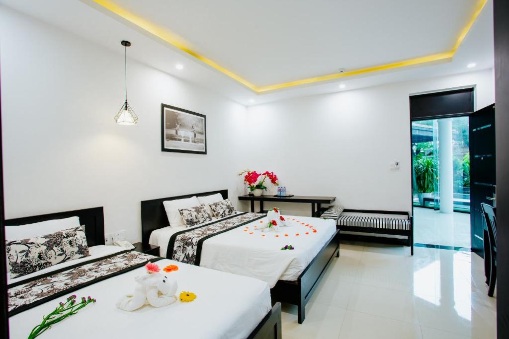 Postel nebo postele na pokoji v ubytování Hoianation Villas Hotel
