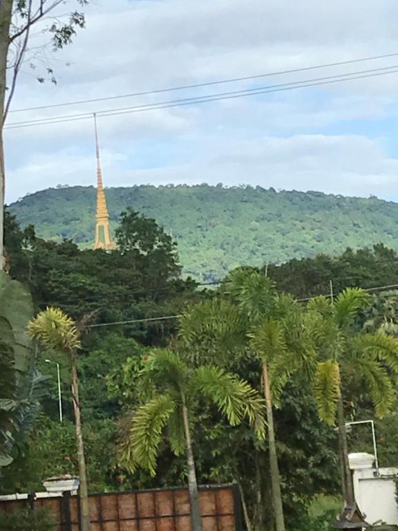 a view of the eiffel tower through the trees at B&B Forest Hill Khao Yai in Ban Noen Hom