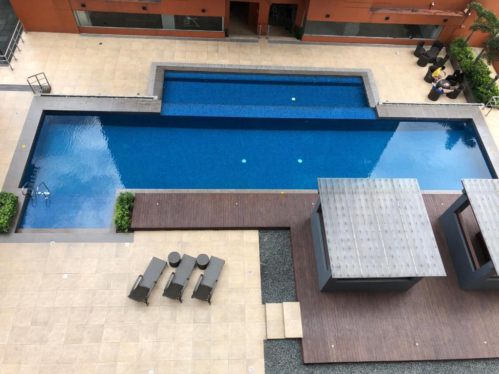 an overhead view of a swimming pool with two chairs at A Home with a view, 1 Bdrm with balcony and Netflix Access in Manila