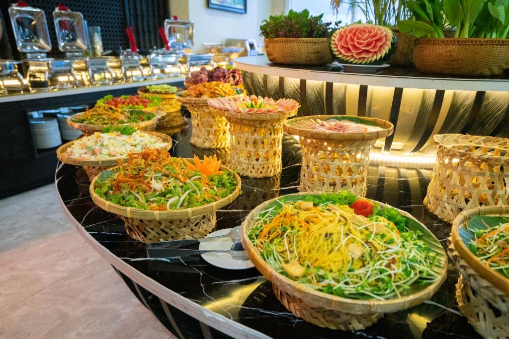 A buffet display with Vietnamese-style dishes and hot food stations.