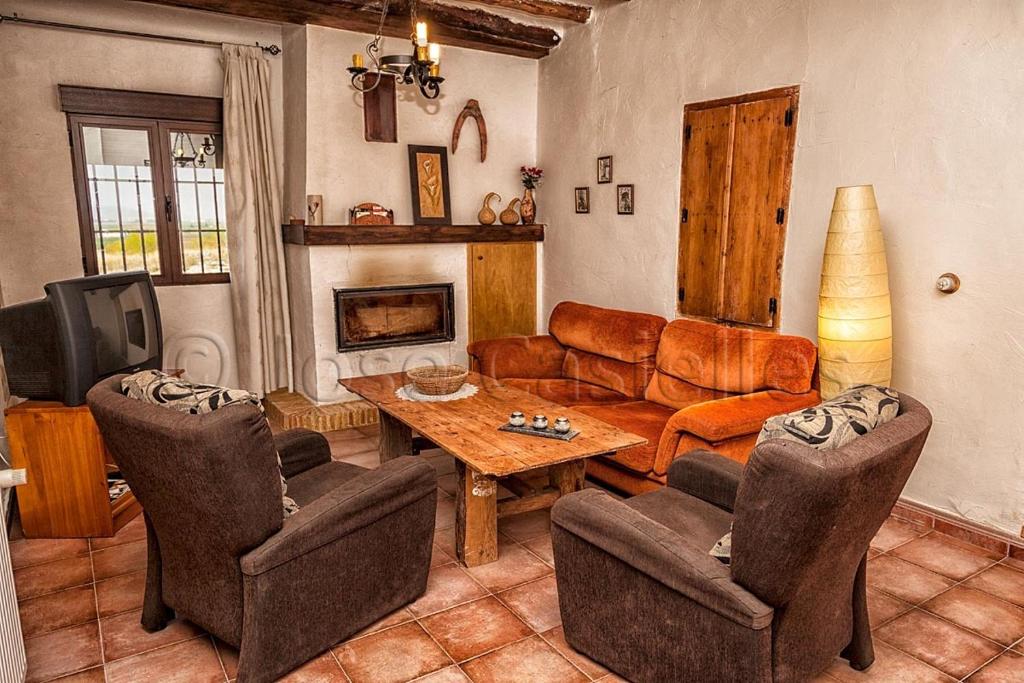 a living room with a couch and a table at Casa Rural Casa Máxima in Yecla