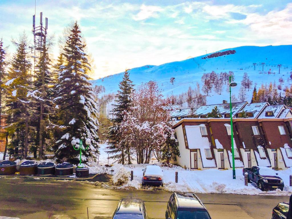 two cars parked in a parking lot in the snow at Boost Your Immo Les Deux Alpes Les Cimes 172 in Les Deux Alpes