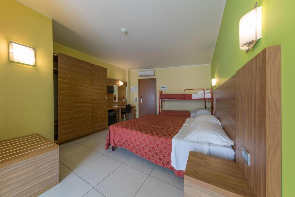 Postel nebo postele na pokoji v ubytování Hotel La Ninfea