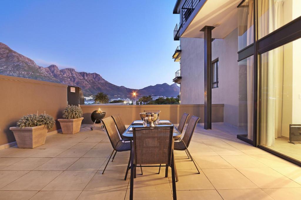 a patio with a table and chairs on a balcony at G Zero 3 @ The Breakers in Hout Bay