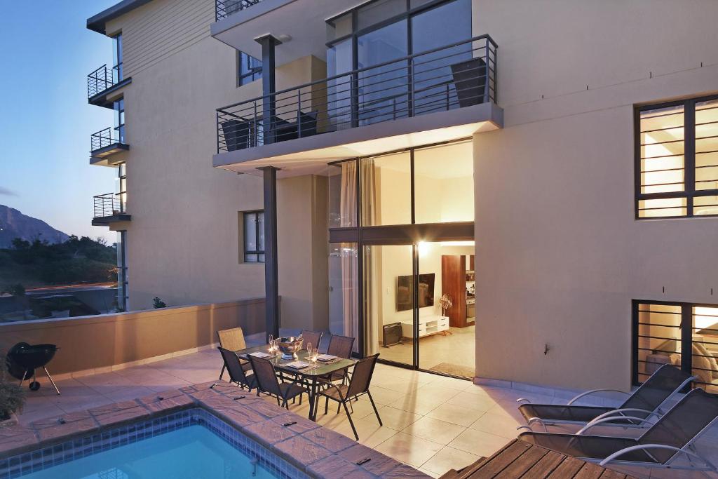 a house with a pool and a table and chairs at G Zero 3 @ The Breakers in Hout Bay