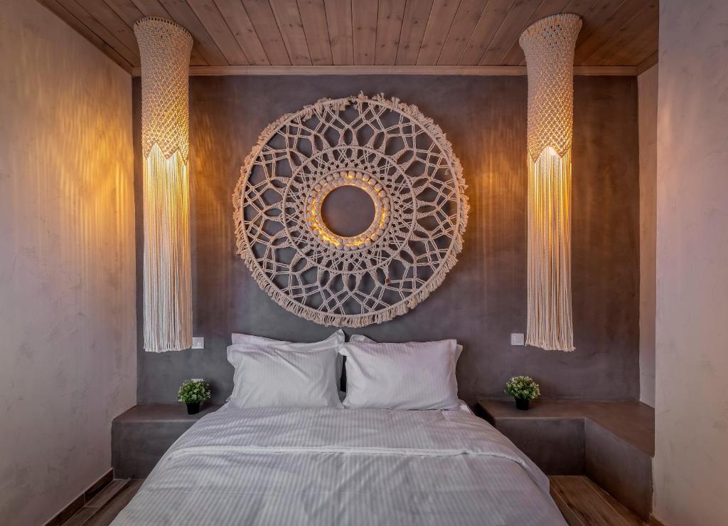 a bedroom with a bed and a mirror on the wall at Macrame Suites in Tríkala